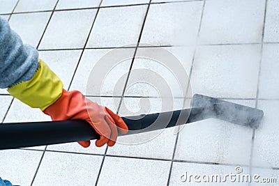 Woman using steam cleaner Stock Photo