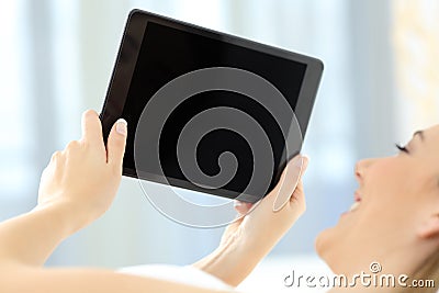 Woman using a tablet showing a blank screen Stock Photo