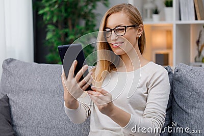 Woman using tablet on sofa Stock Photo