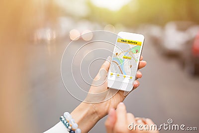 Woman using taxi app on mobile phone Stock Photo