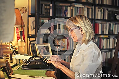 Woman using a typing machine Stock Photo