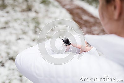 Woman using wearable tech during fitness activities Stock Photo