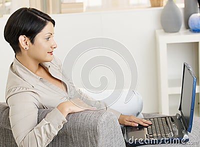Woman using wireless network at home Stock Photo
