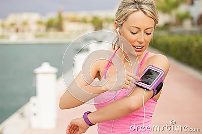 Woman using workout app on her smartphone Stock Photo
