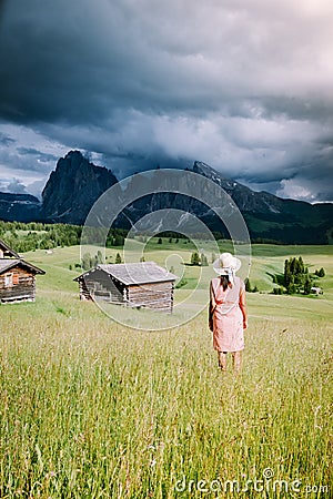 Woman on vacation in the Dolomites Italy,Alpe di Siusi - Seiser Alm with Sassolungo - Langkofel mountain group in Stock Photo