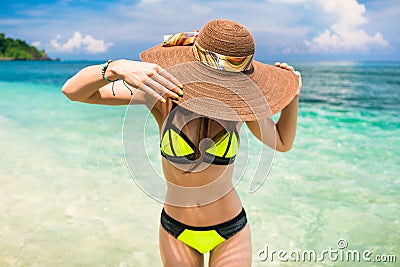 Woman on vacation wearing beach hat bathing in ocean Stock Photo