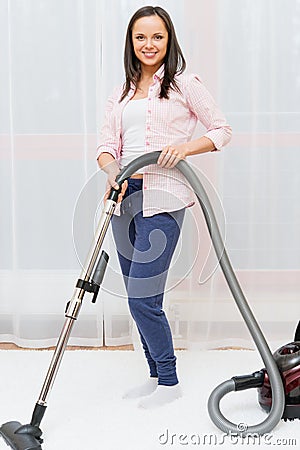 Woman vacuum cleaning carpet Stock Photo