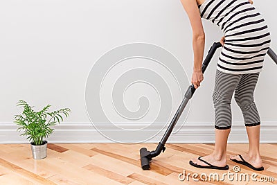 Woman vacuum cleaning the room Stock Photo