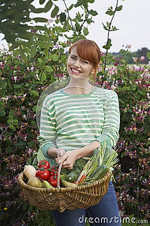 Woman With Vegetable Basket Outdoors Stock Photo