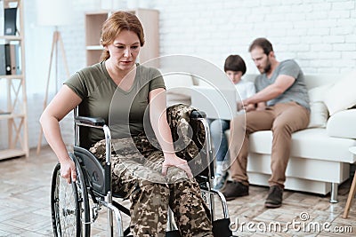 Woman veteran in wheelchair returned from army. A woman in a wheelchair is in pain. She`s in military uniform. Stock Photo