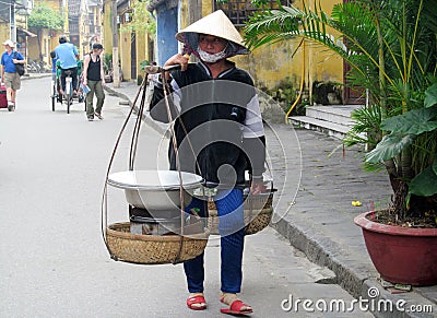 Woman in Vietnam wearing traditional triangular straw palm hats Editorial Stock Photo