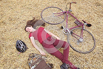 Woman with vintage bike , backbag and helmet in hay Stock Photo