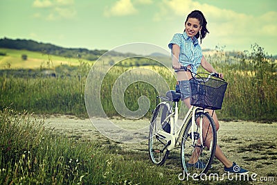 Woman with vintage bike outdoor, summer Tuscany Stock Photo