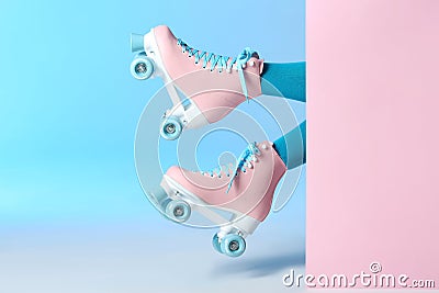 Woman with vintage roller skates on color background Stock Photo