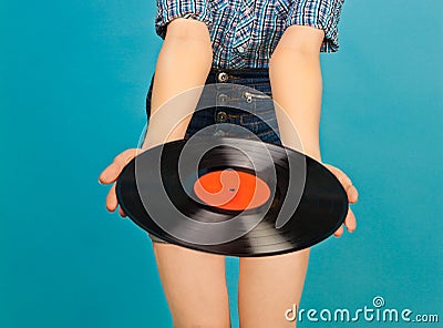 Woman with vinyl record on blue background Stock Photo