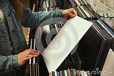 Woman with vinyl record in store Stock Photo