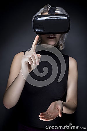 Woman with Virtual Reality Headset Touching Something Stock Photo