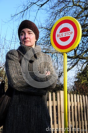 Woman waiting at bus stop Stock Photo