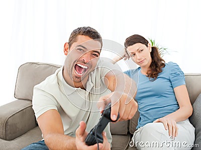 Woman waiting for her boyfriend playing video game Stock Photo