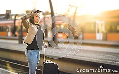 Woman waiting for train in station. Lady standing in platform. Stock Photo