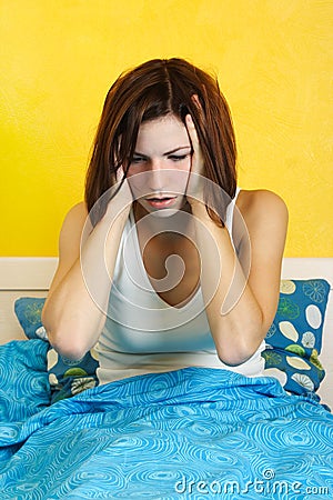 Woman waking up after nightmare, hands on head Stock Photo