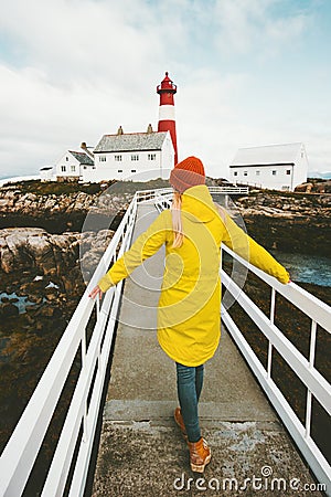 Woman walking alone on bridge at lighthouse Traveling Stock Photo
