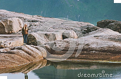 Woman walking alone enjoying seaside rocks view outdoor Stock Photo