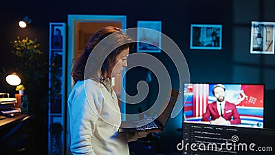 Woman walking around home fixing coding issues, upset about errors Stock Photo