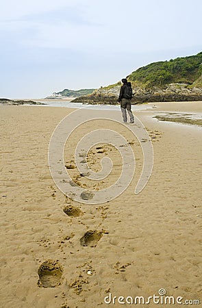 Woman walking on beach Stock Photo