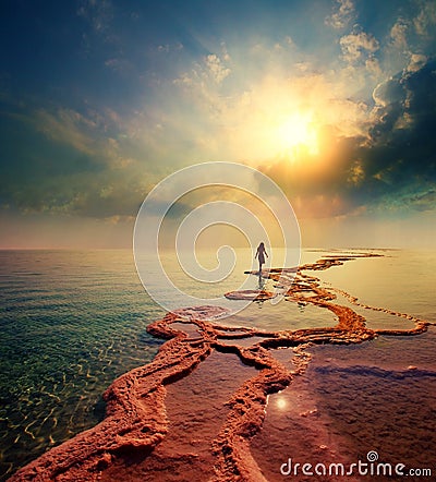 Woman walking on Dead Sea salt shore Stock Photo