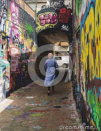 Woman walking down Graffiti street Editorial Stock Photo