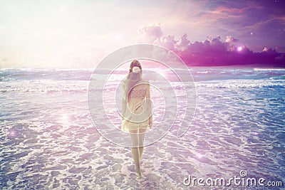 Woman walking on dreamy beach enjoying ocean view Stock Photo