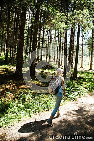 A woman walking on forest road during summer vocation - keep in shape Stock Photo