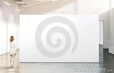 Woman walking near blank white wall mockup in modern gallery Stock Photo