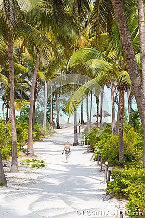 Woman walking on Paje beach, Zanzibar. Stock Photo