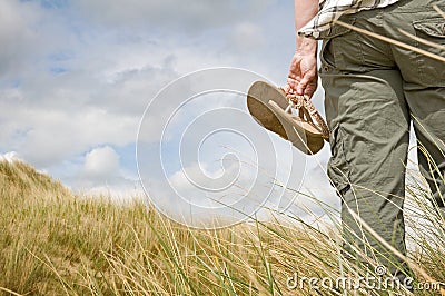 Woman walking in sand dunes Stock Photo