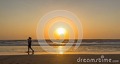 Woman are walking at sunseton Arambol beach, Goa, India Editorial Stock Photo