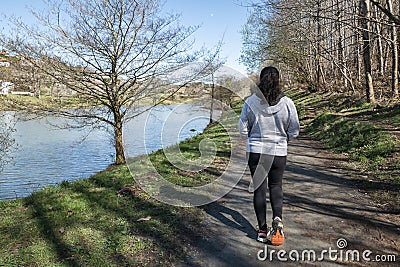 Tourist woman braves lakeside trail Stock Photo