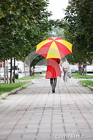Woman walking with an umbrella Stock Photo