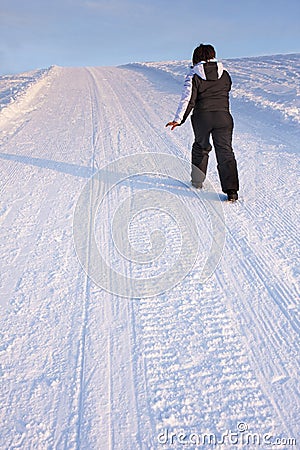 Woman Walking Uphill Snow Mountain Track Stock Photo