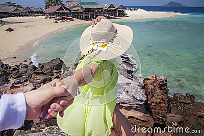Woman wanting her man to follow her in vacation or honeymoon to beach by the ocean, love, hair wild Stock Photo
