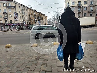 Woman with two big blue plastic bags Stock Photo