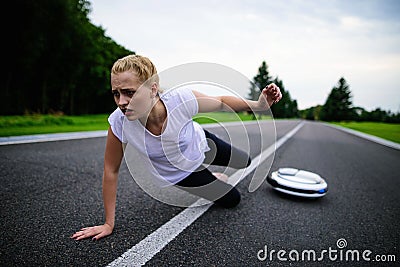 The woman was driving along the park path on the monocycle and fell. It hurts Stock Photo