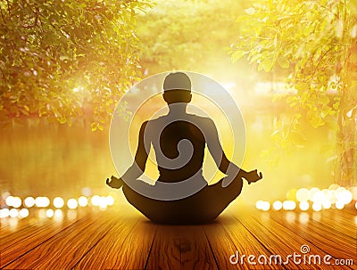 Woman was meditating in sunrise and rays of light on park and nature Stock Photo