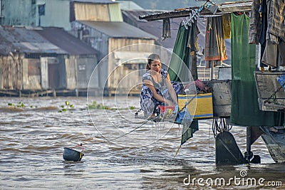 Woman washing clothes in Mekong river Editorial Stock Photo