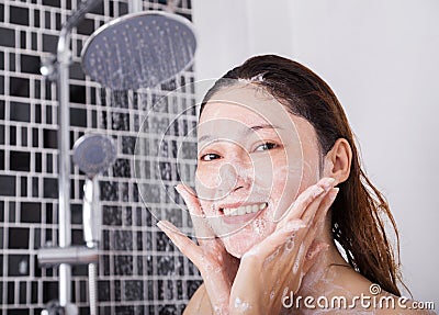 Woman washing face in shower foaming Stock Photo