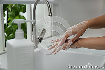 Woman washing hands with antibacterial soap indoors, closeup. Personal hygiene during COVID-19 pandemic Stock Photo