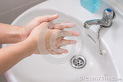Woman Washing hands with liquid soap Step 3: Interlink your fingers, against Novel coronavirus or Corona Virus Disease Covid-19 Stock Photo
