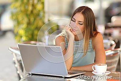 Woman watching a laptop in a restaurant Stock Photo