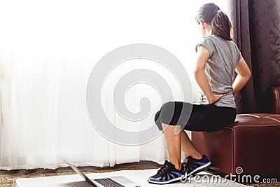 Woman watching online tutorials on laptop Stock Photo